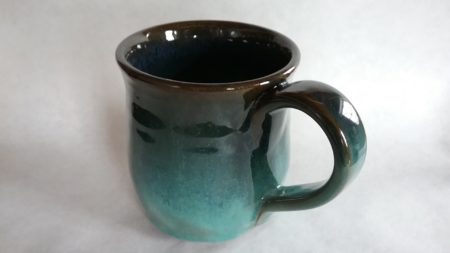 Black stoneware mug, copper and blue glazes